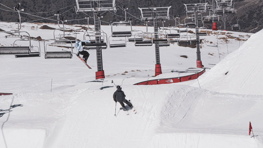 A skier following another skier, while filming using the RAV powder baskets